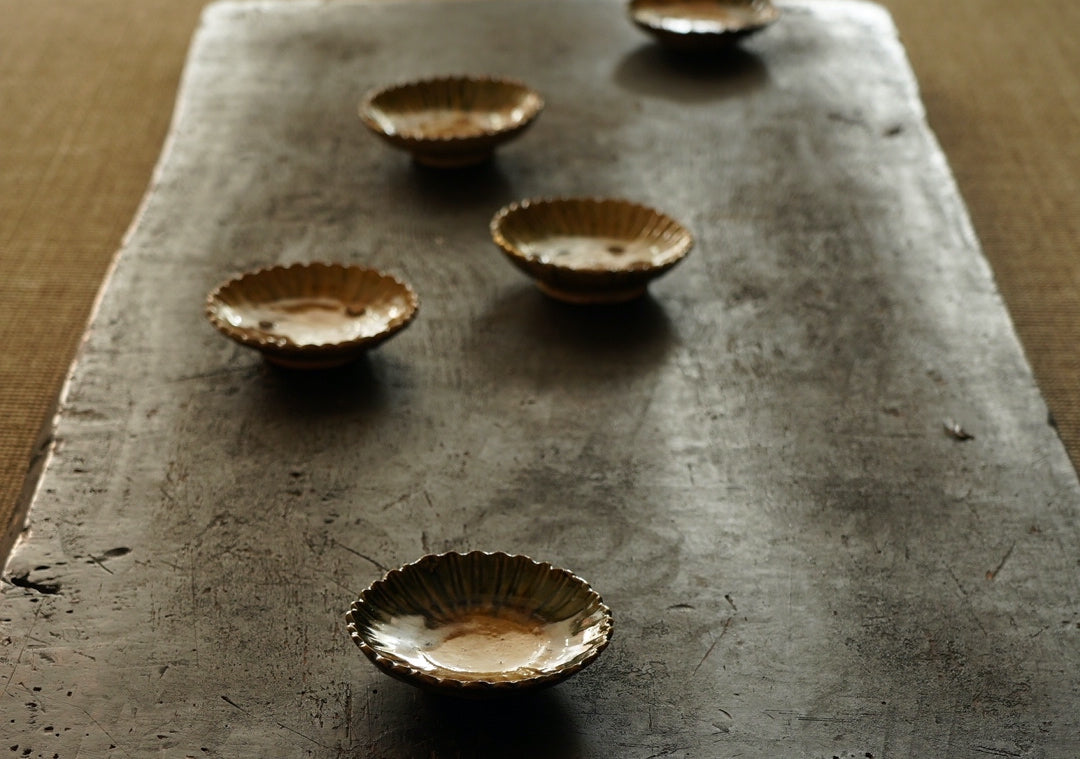 A set of five Oribe green glazed dishes in chrysanthemum design