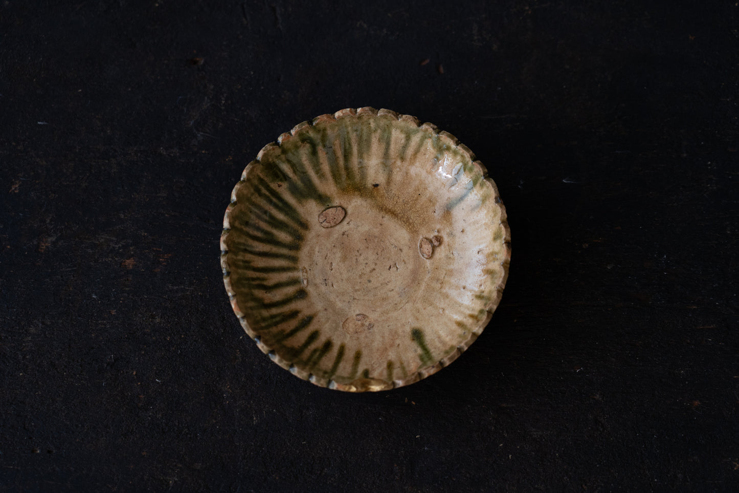 A set of five Oribe green glazed dishes in chrysanthemum design