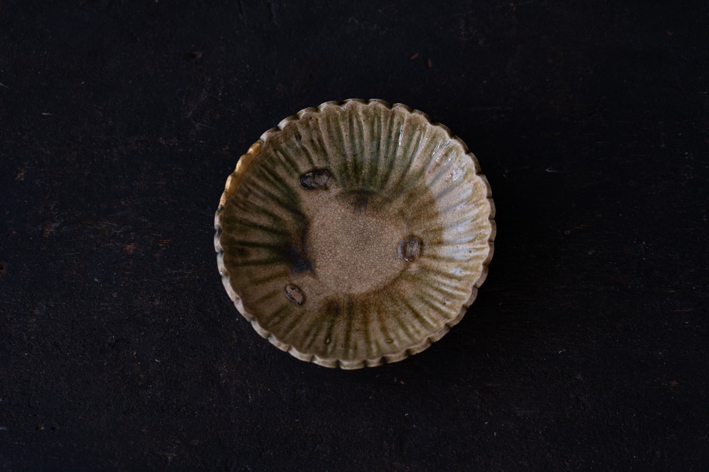 A set of five Oribe green glazed dishes in chrysanthemum design