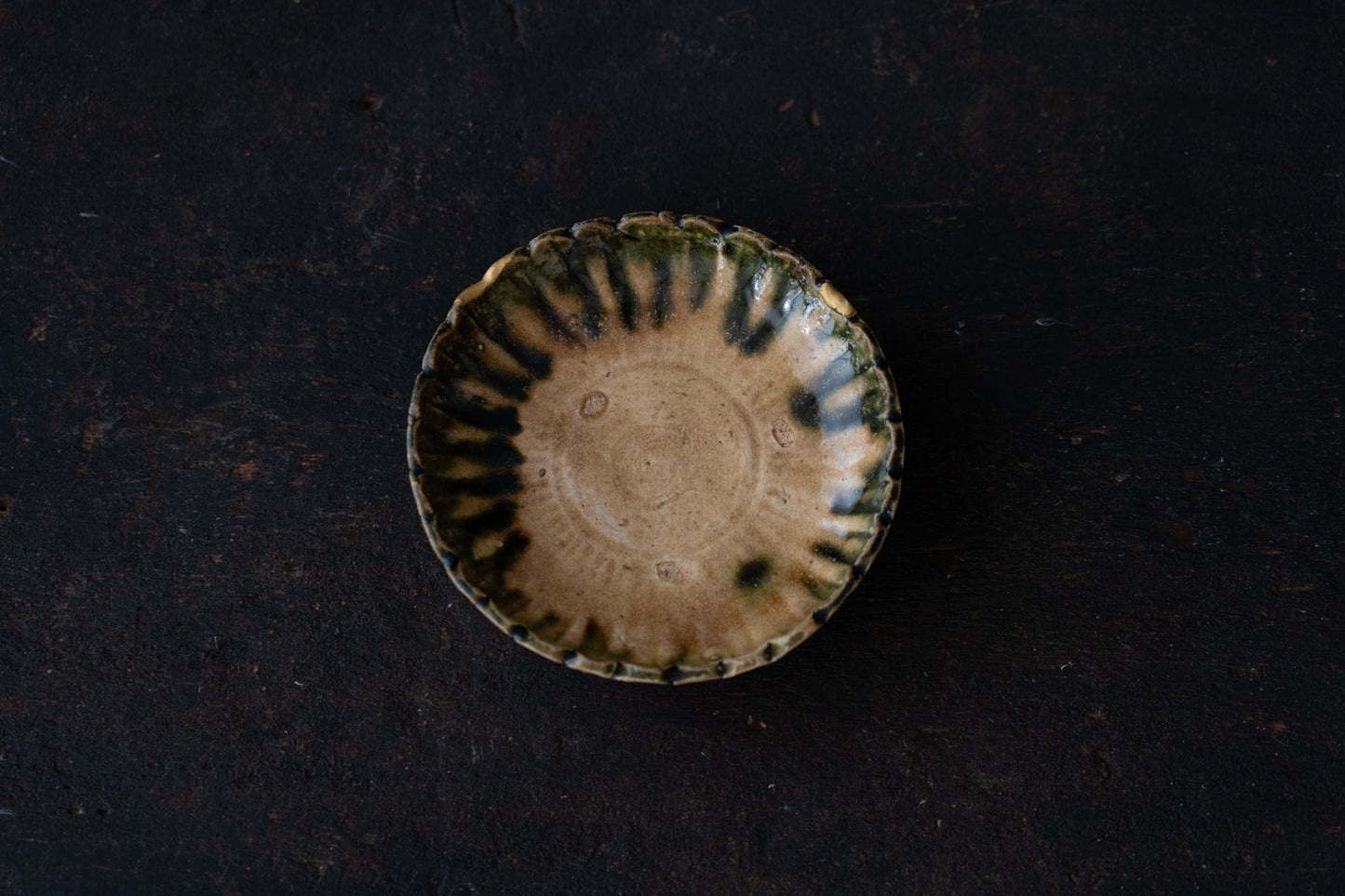 A set of five Oribe green glazed dishes in chrysanthemum design