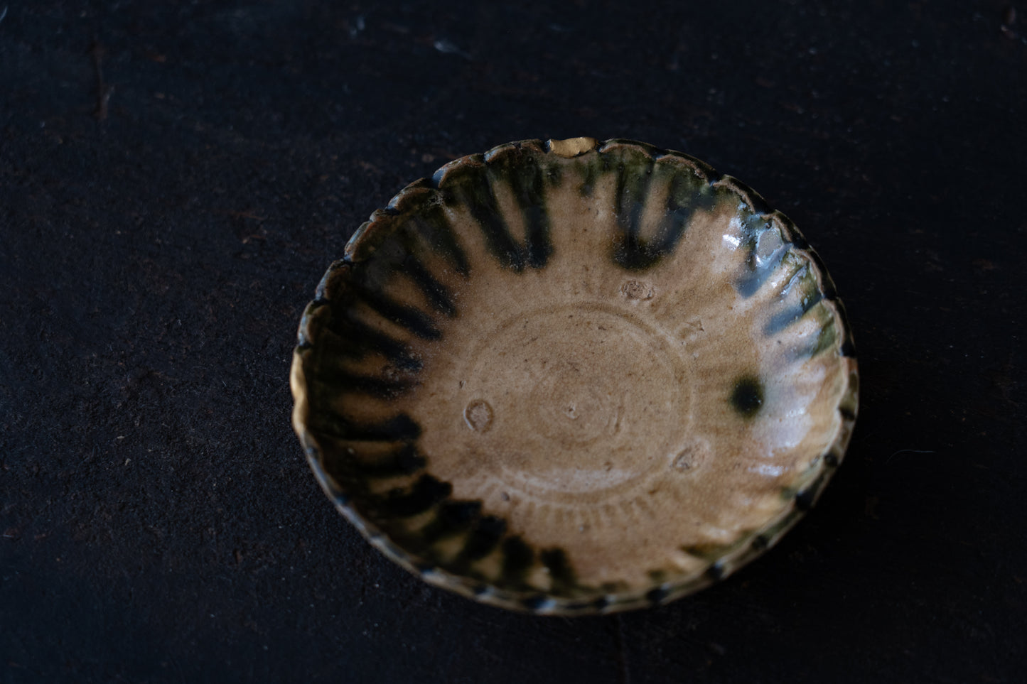 A set of five Oribe green glazed dishes in chrysanthemum design