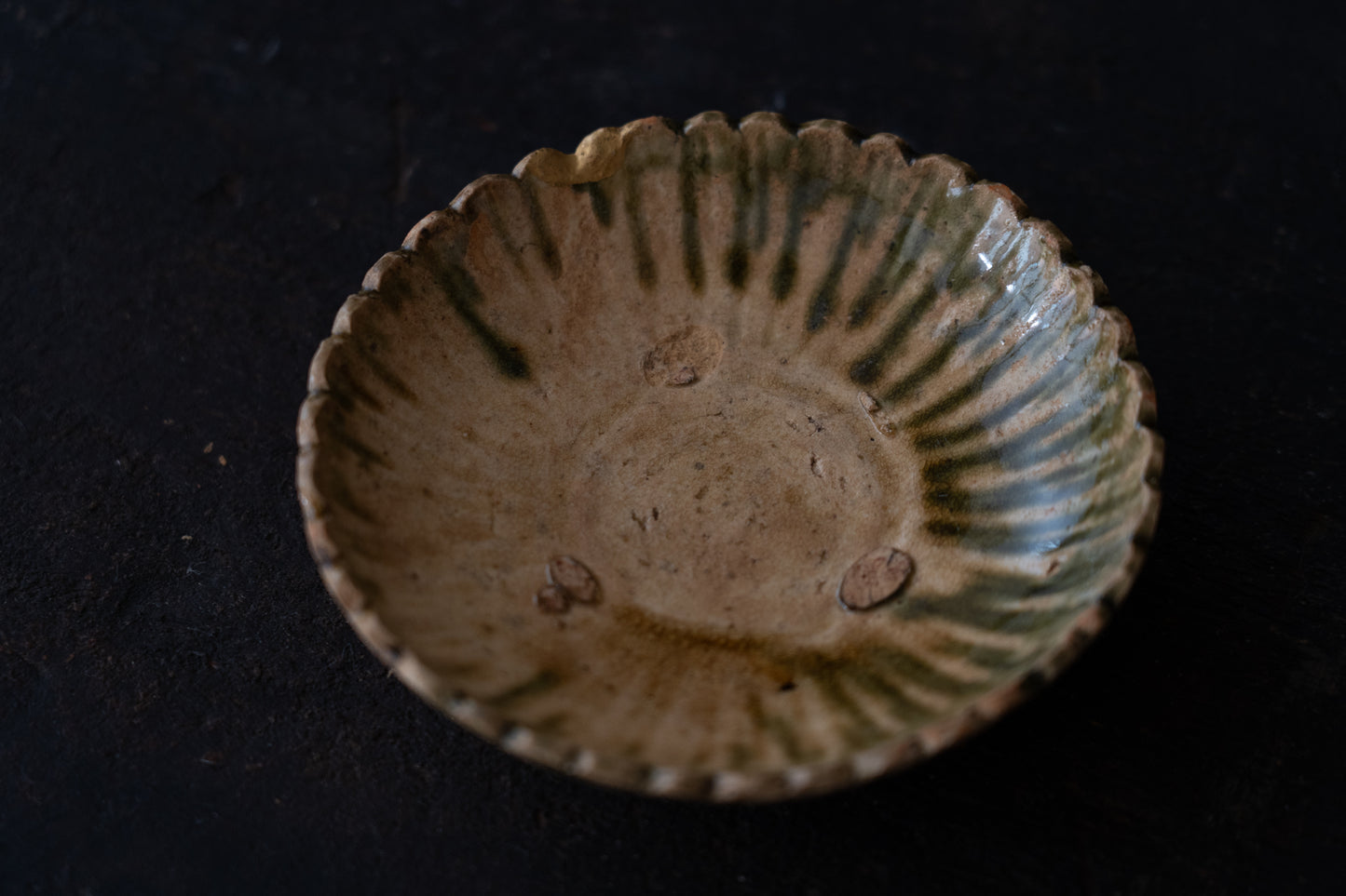A set of five Oribe green glazed dishes in chrysanthemum design