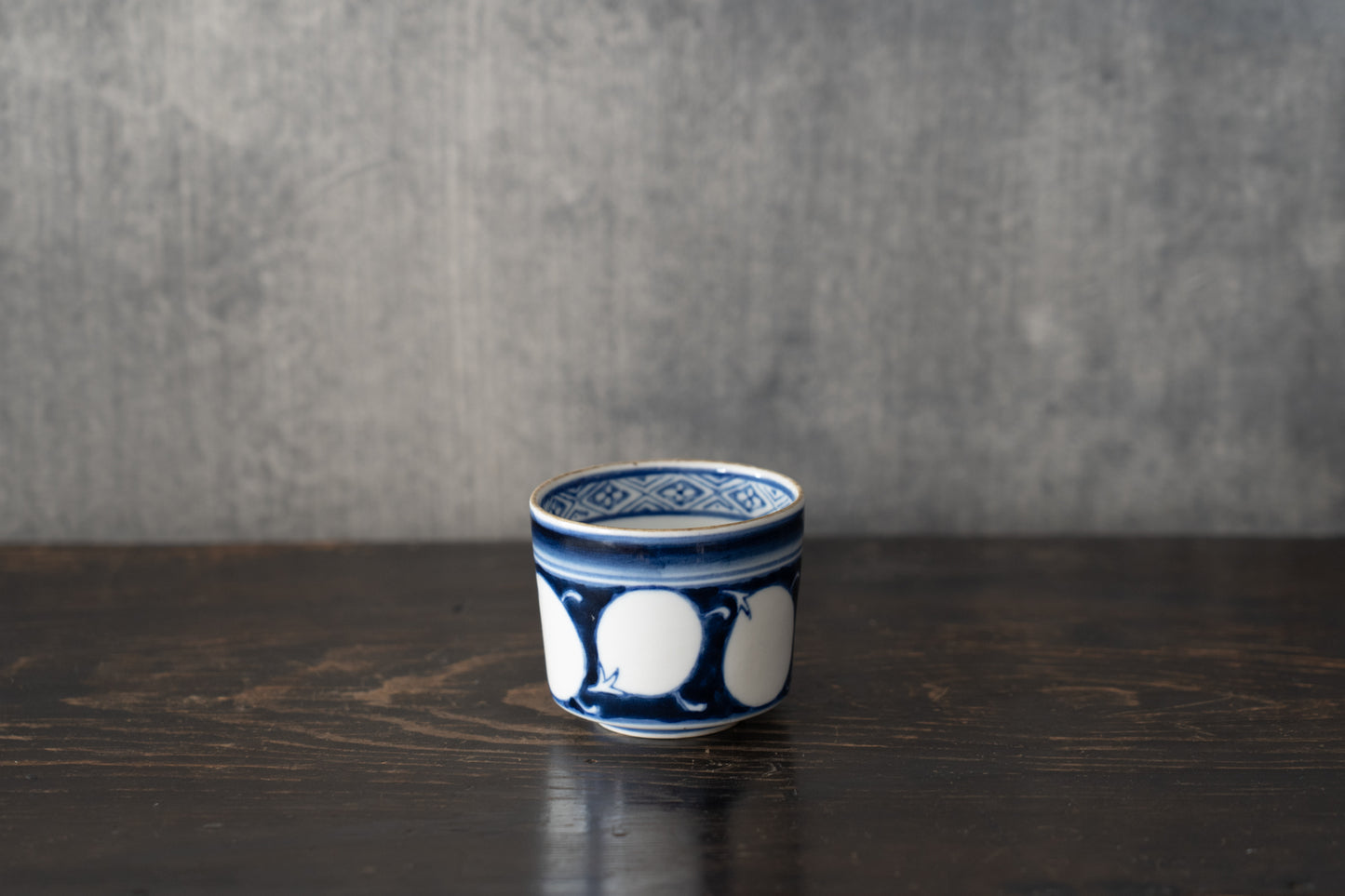 Old Imari sake cup with eggplant design