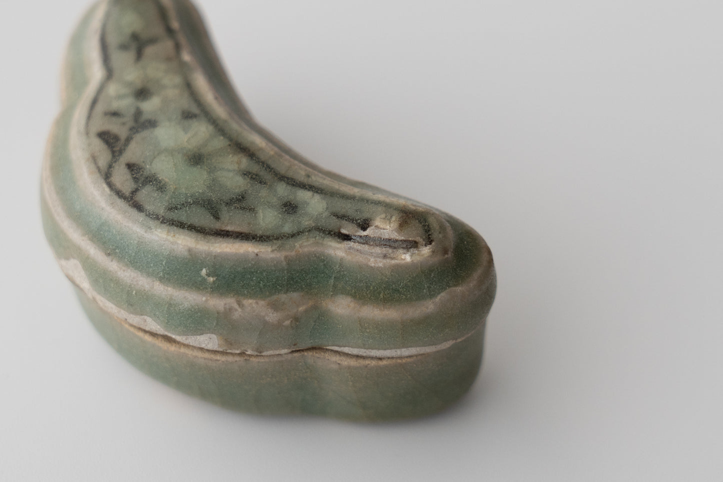 Celadon incense container with inlaid flower design