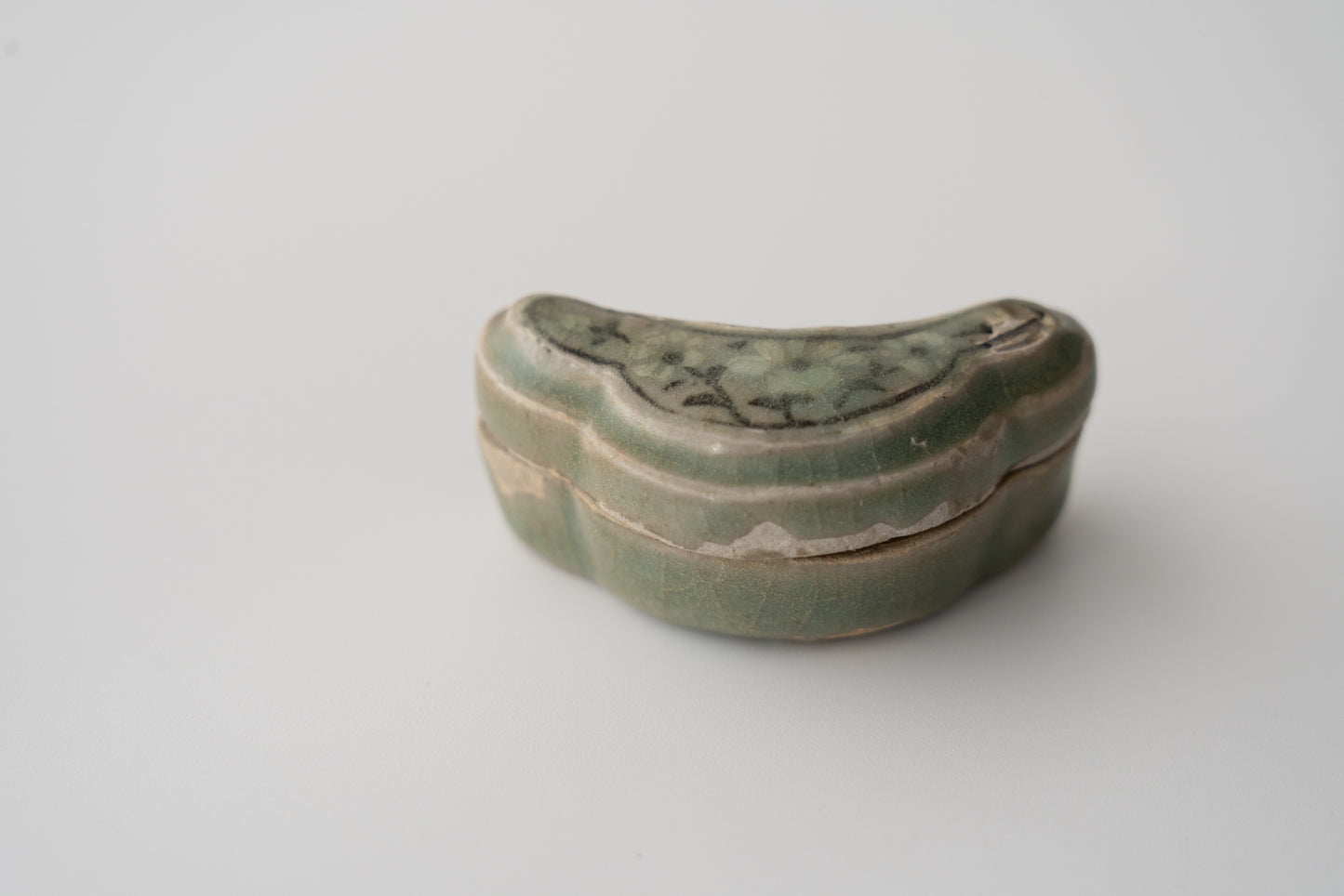 Celadon incense container with inlaid flower design