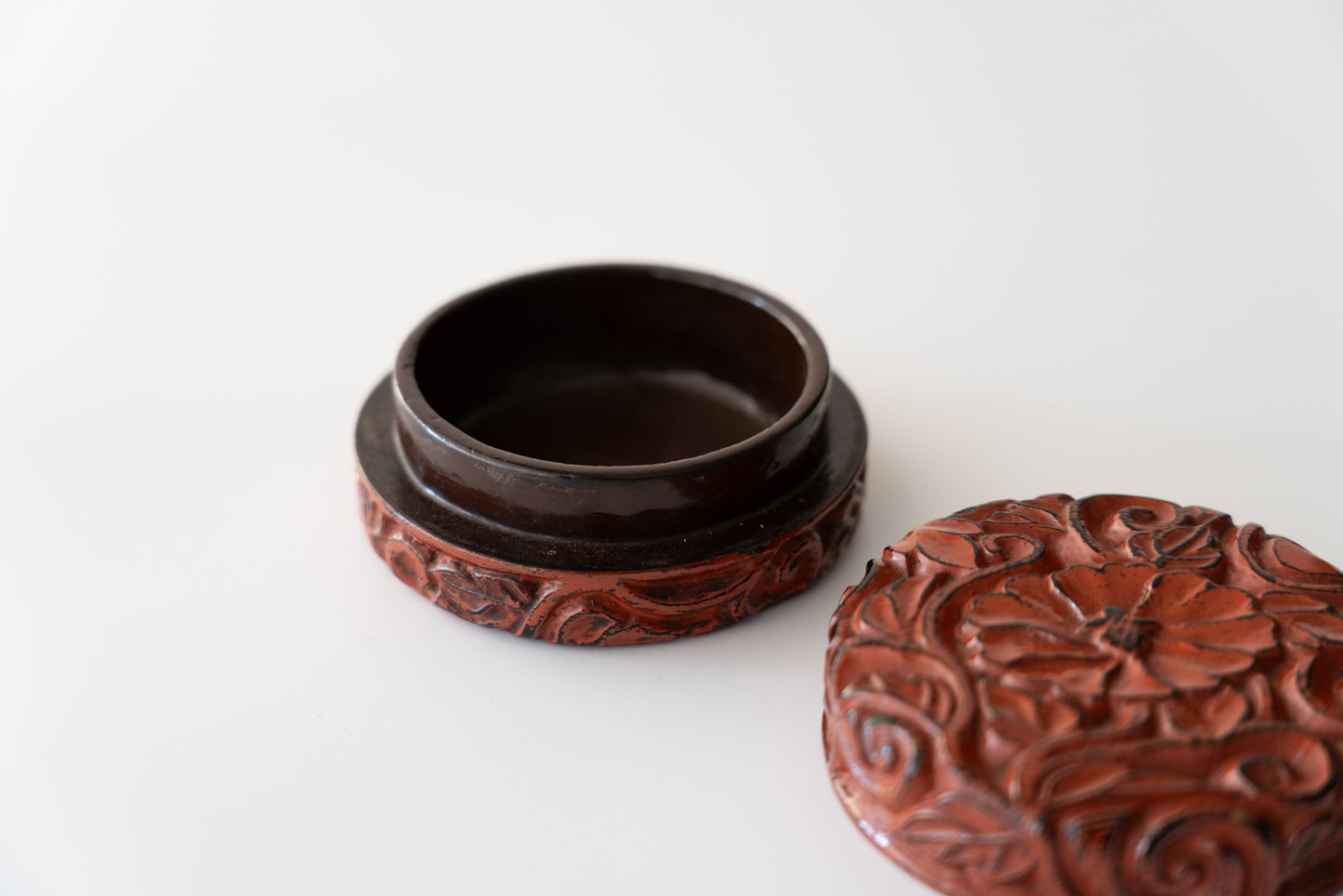 Lacquered incense container with peony design in wood carving