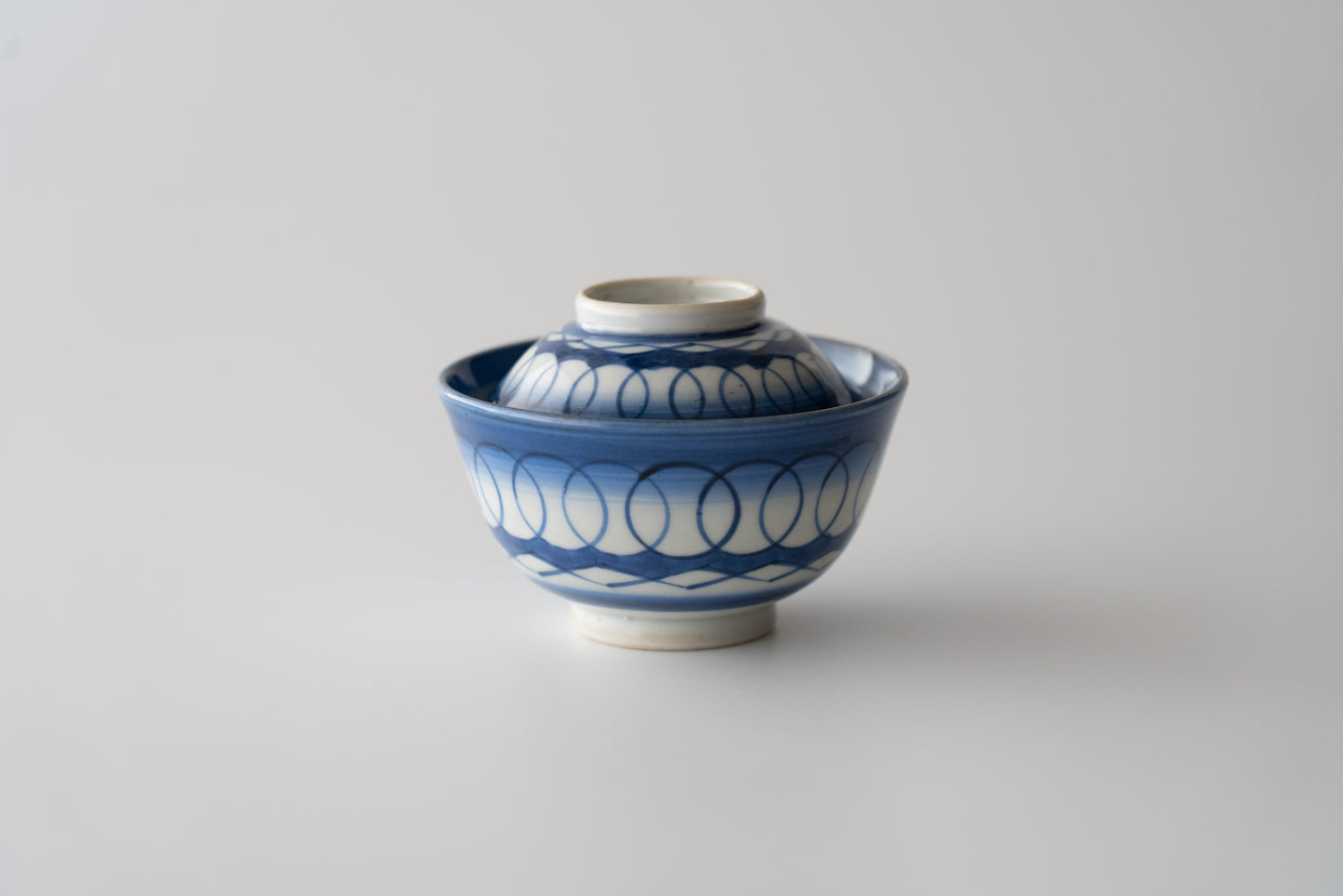 Old Imari tea bowl with a lid and a connecting pattern