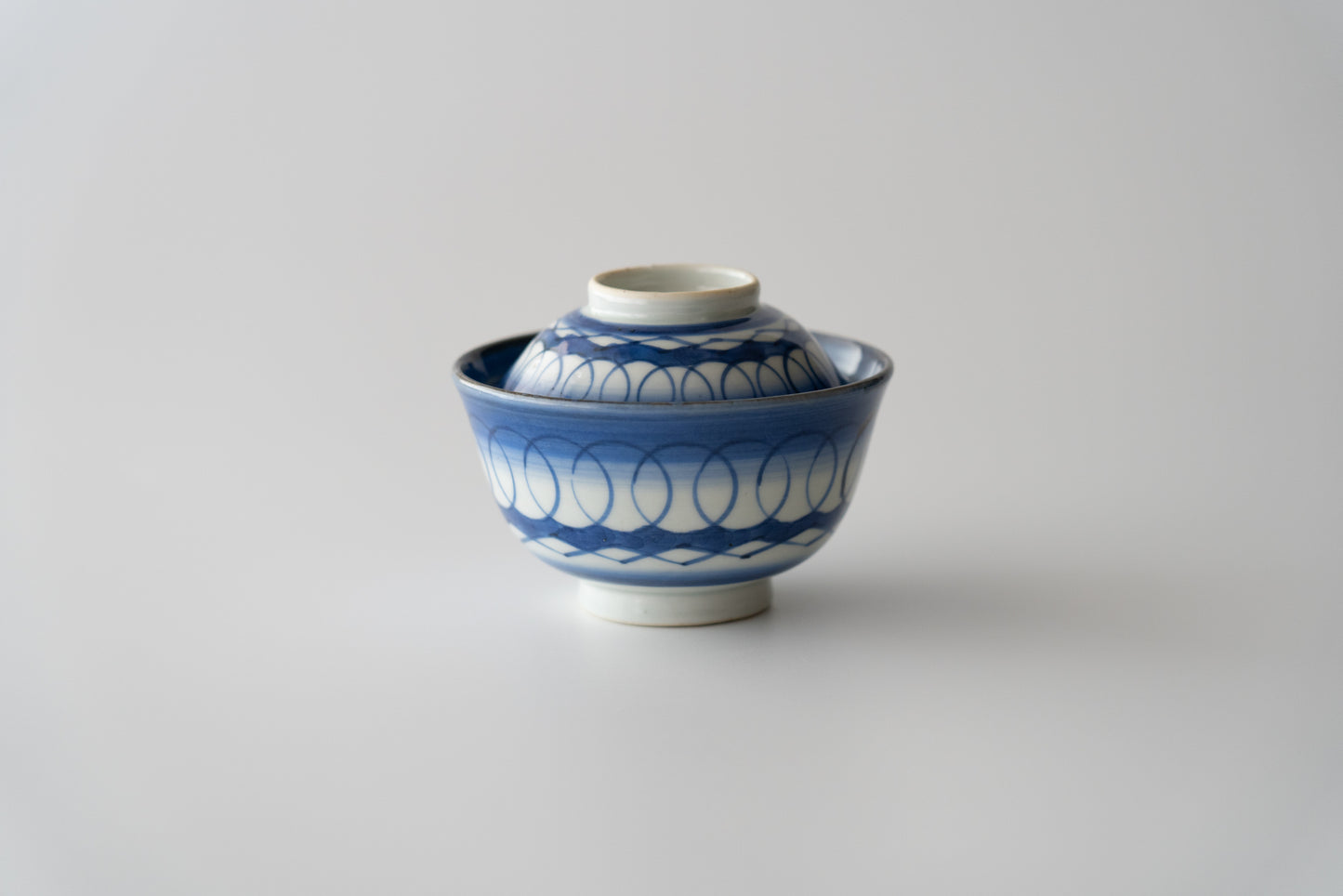 Old Imari tea bowl with a lid and a connecting pattern