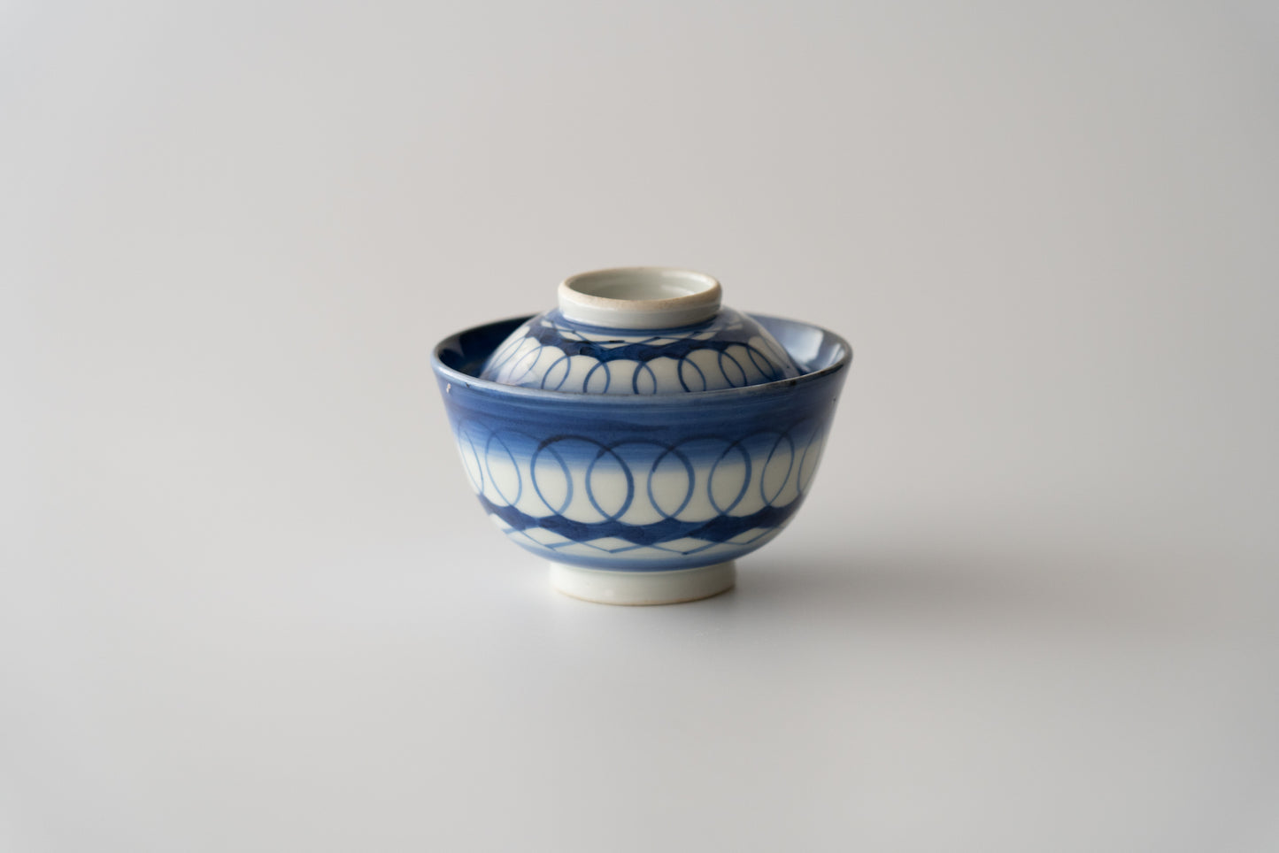 Old Imari tea bowl with a lid and a connecting pattern