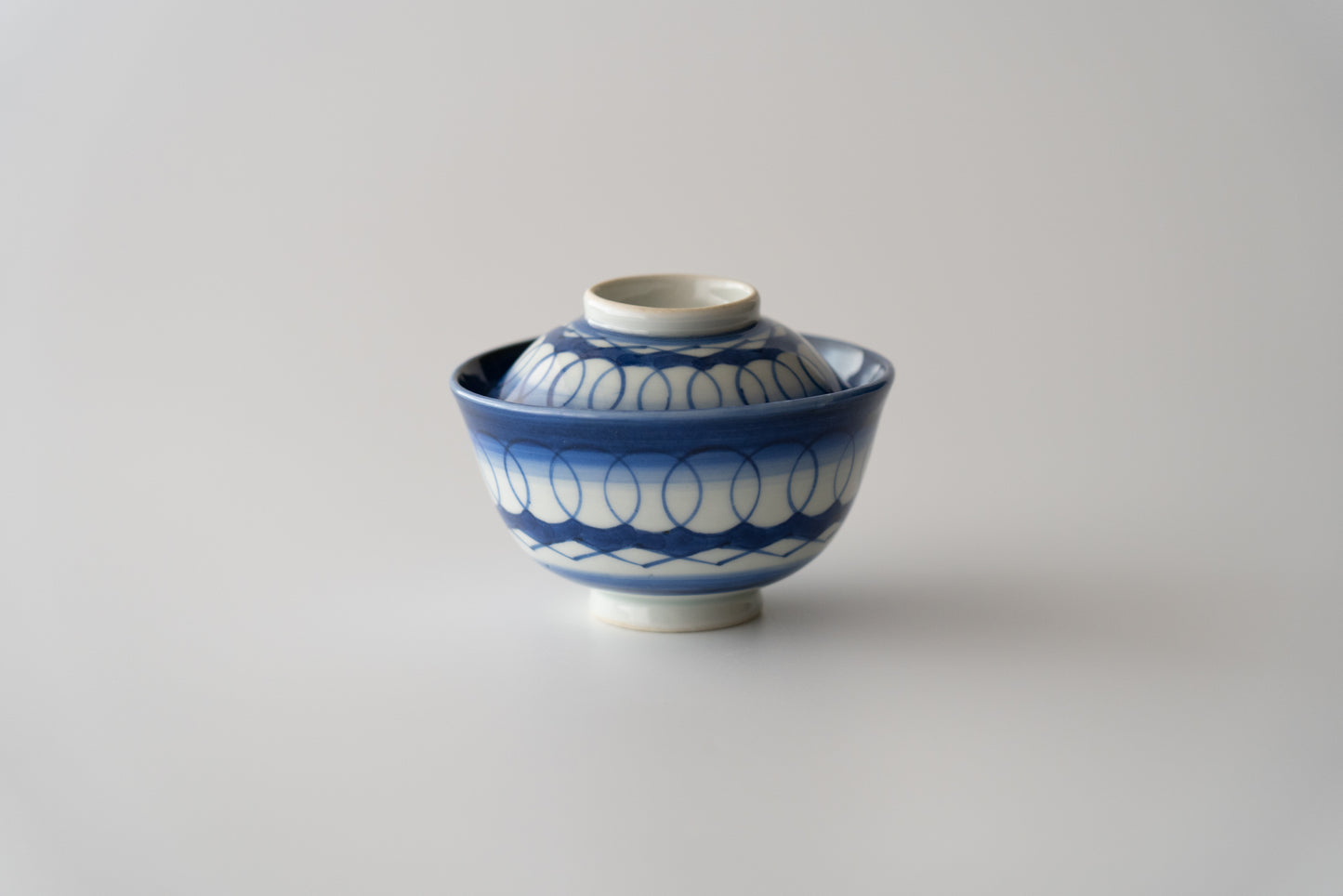 Old Imari tea bowl with a lid and a connecting pattern