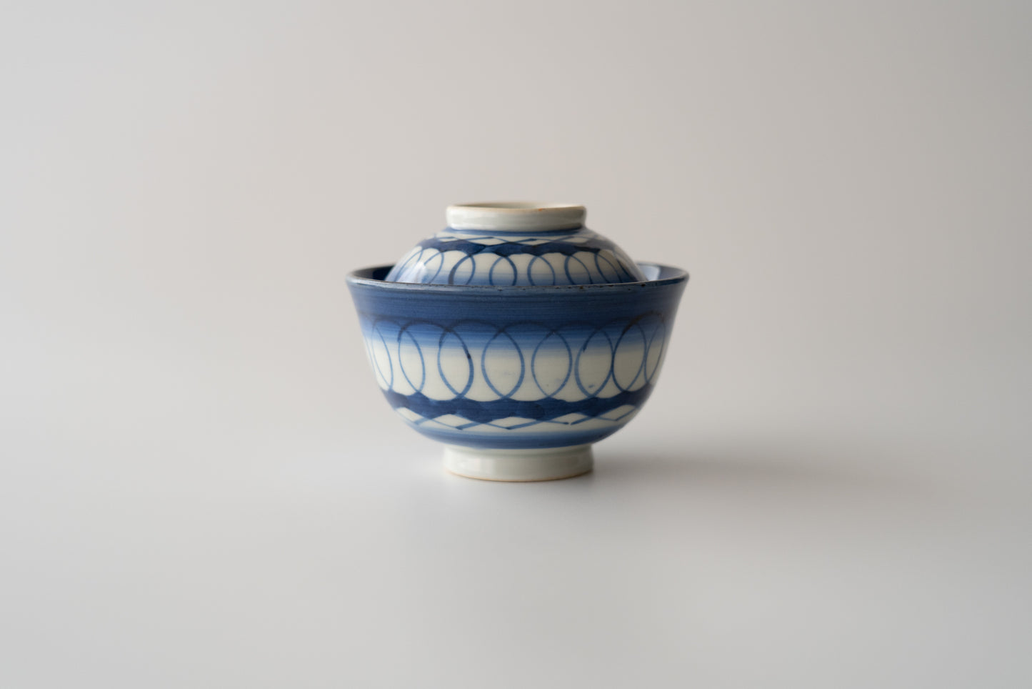 Old Imari tea bowl with a lid and a connecting pattern