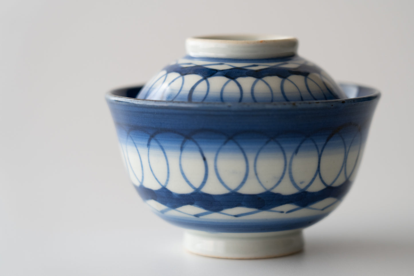 Old Imari tea bowl with a lid and a connecting pattern