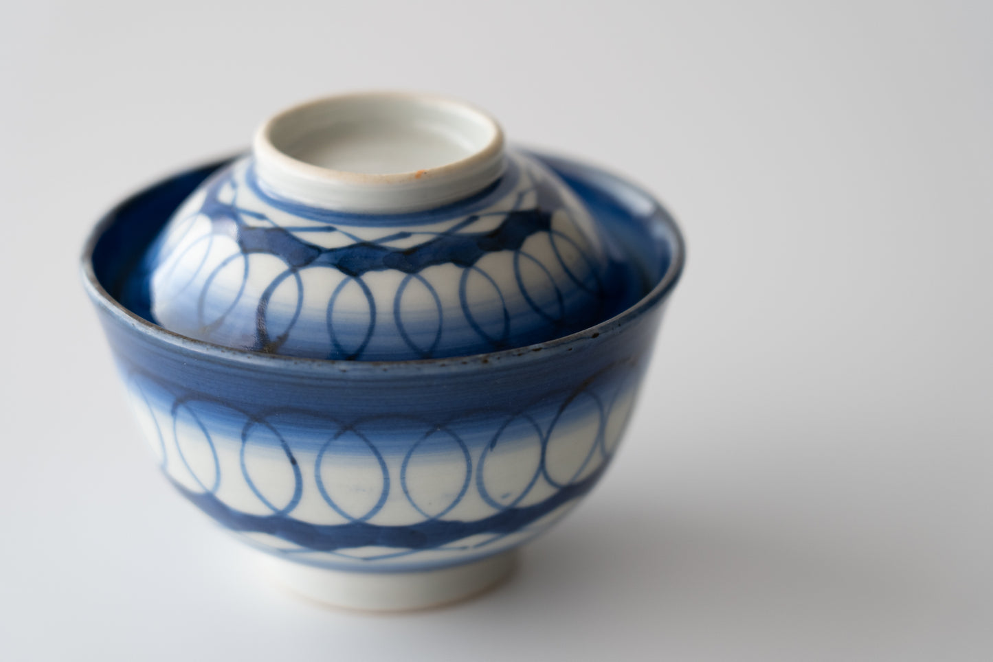 Old Imari tea bowl with a lid and a connecting pattern