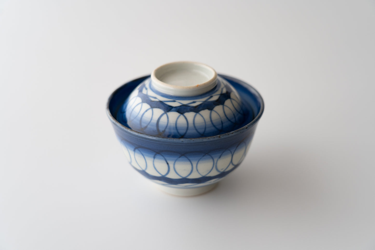 Old Imari tea bowl with a lid and a connecting pattern