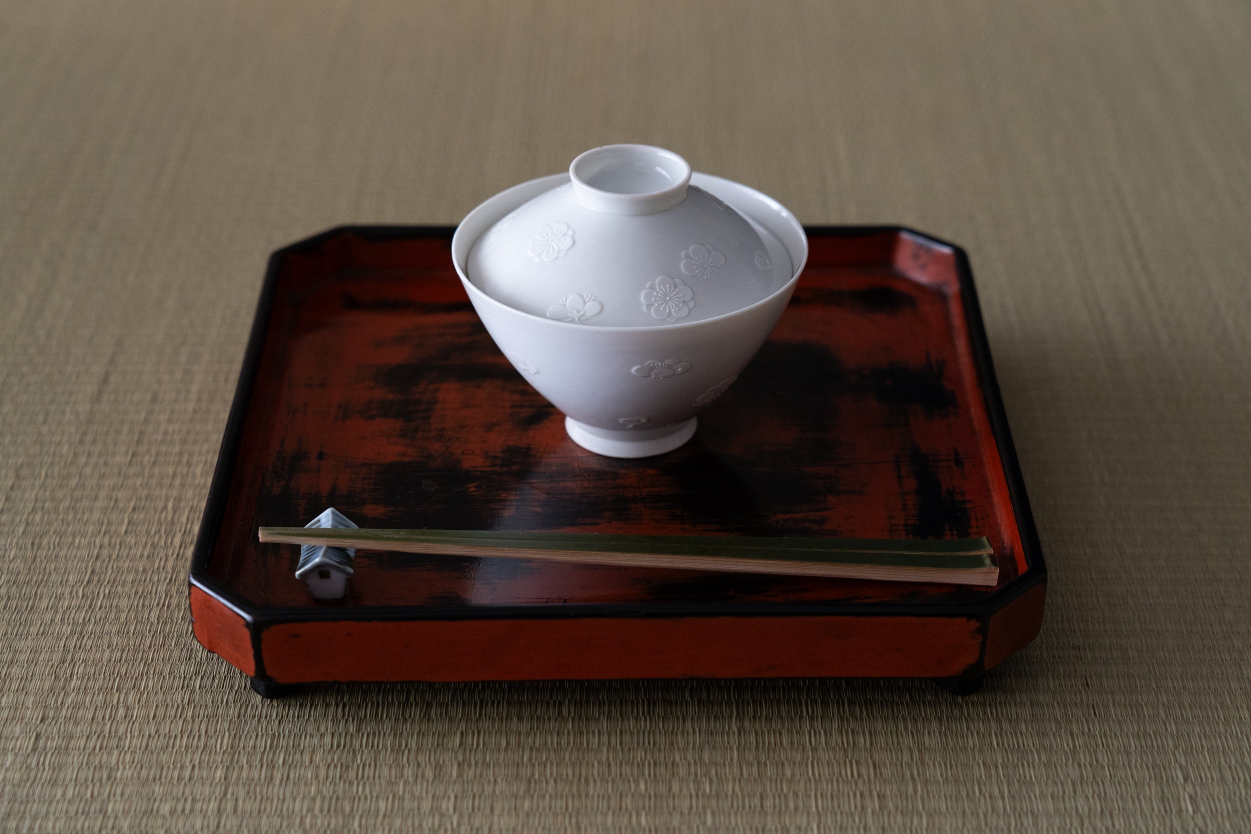 Kakiemon white porcelain bowl with embossed plum blossom design