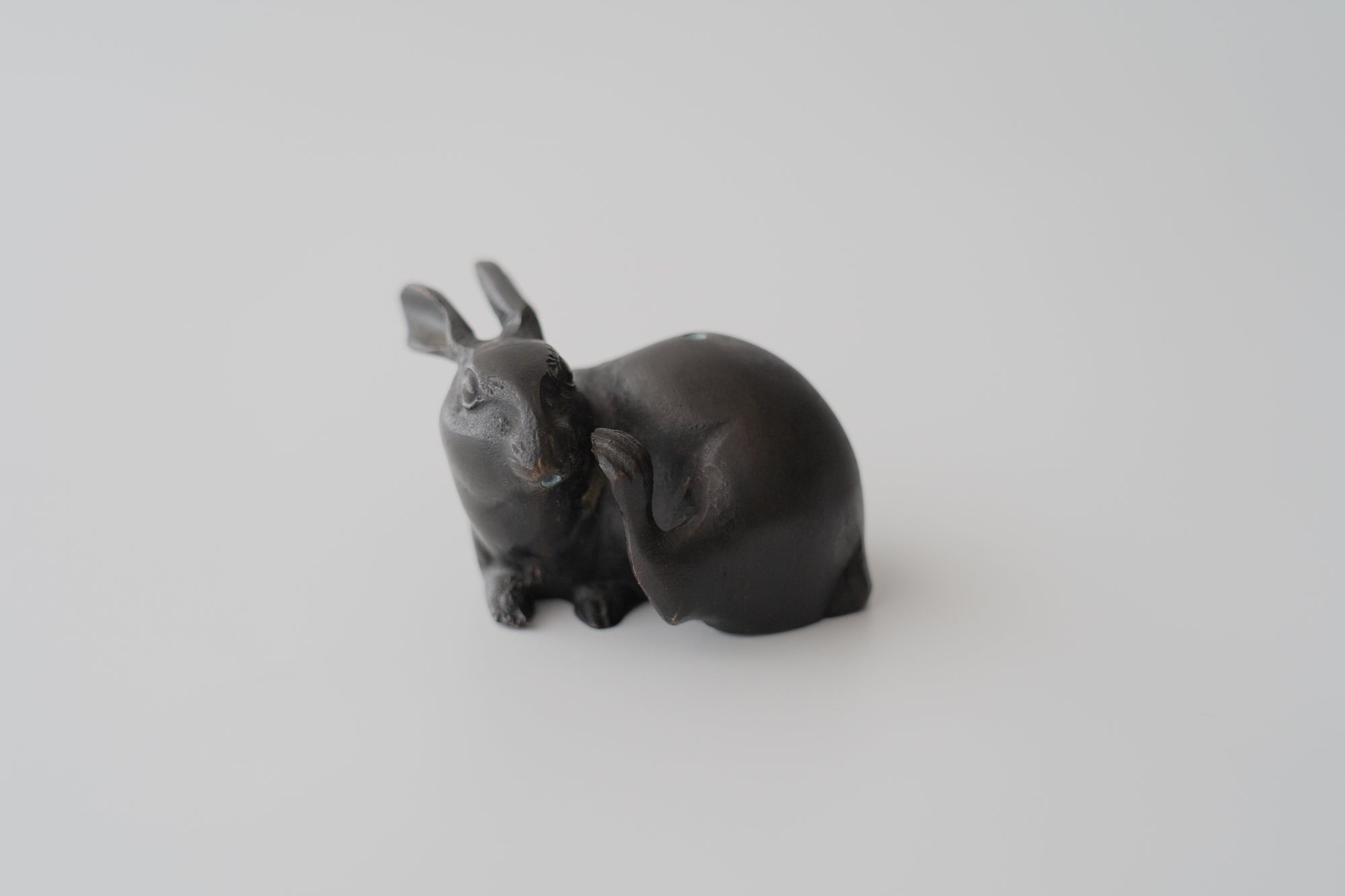 Old bronze water dropper in the shape of a rabbit