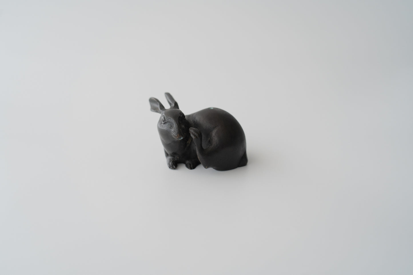 Old bronze water dropper in the shape of a rabbit