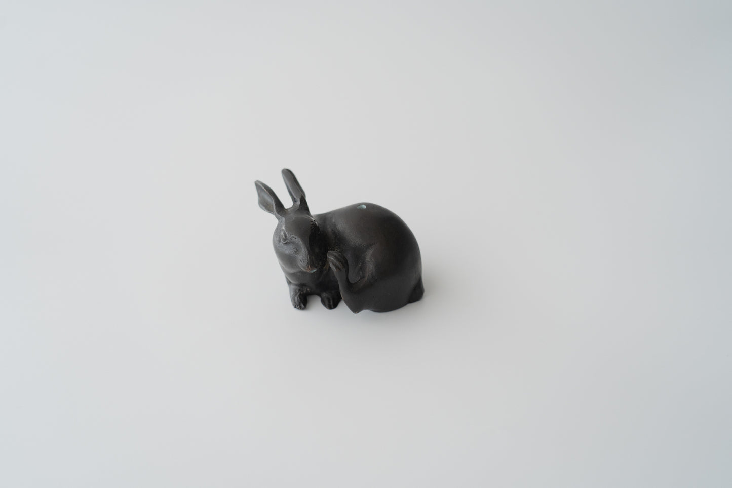 Old bronze water dropper in the shape of a rabbit