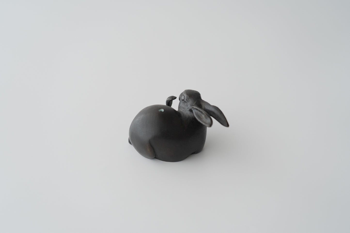 Old bronze water dropper in the shape of a rabbit