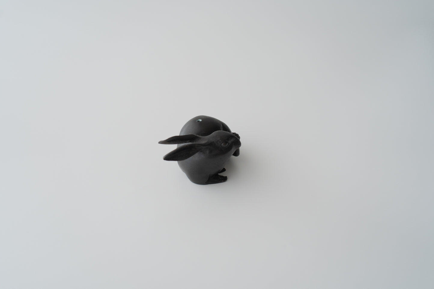 Old bronze water dropper in the shape of a rabbit